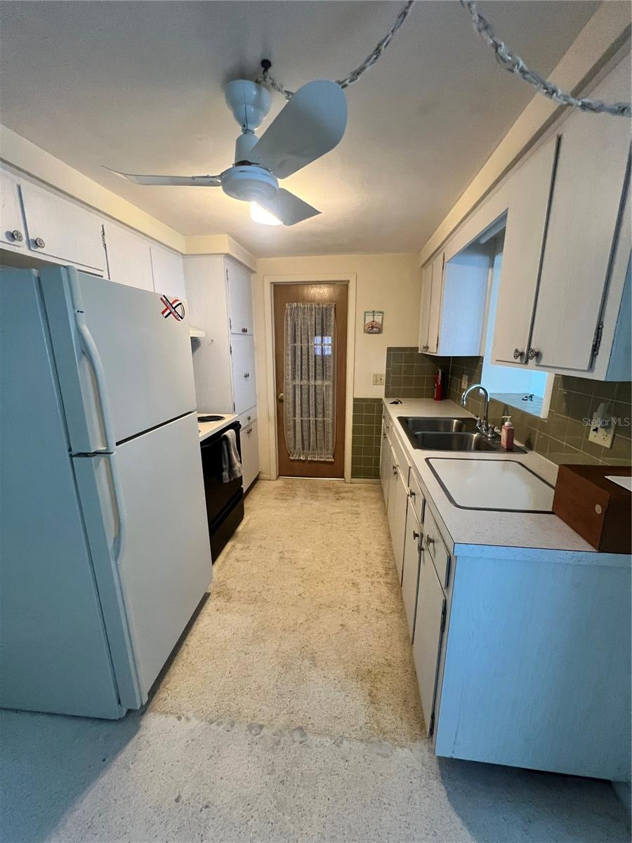 2 piece kitchen.  View from kitchenette.  Door leads to garage.