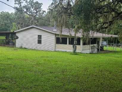 Rear view of home property is fenced