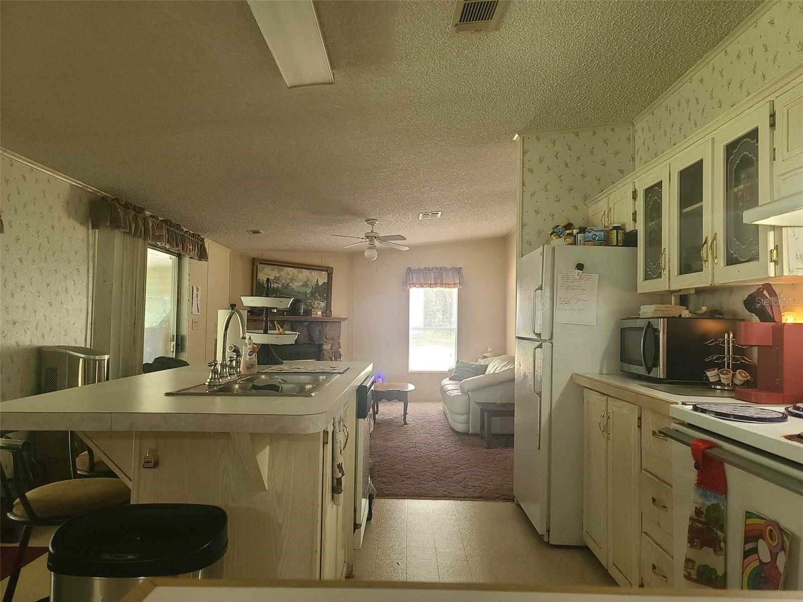 Center Island Kitchen has FR Fireplace and Slider to Back Porch
