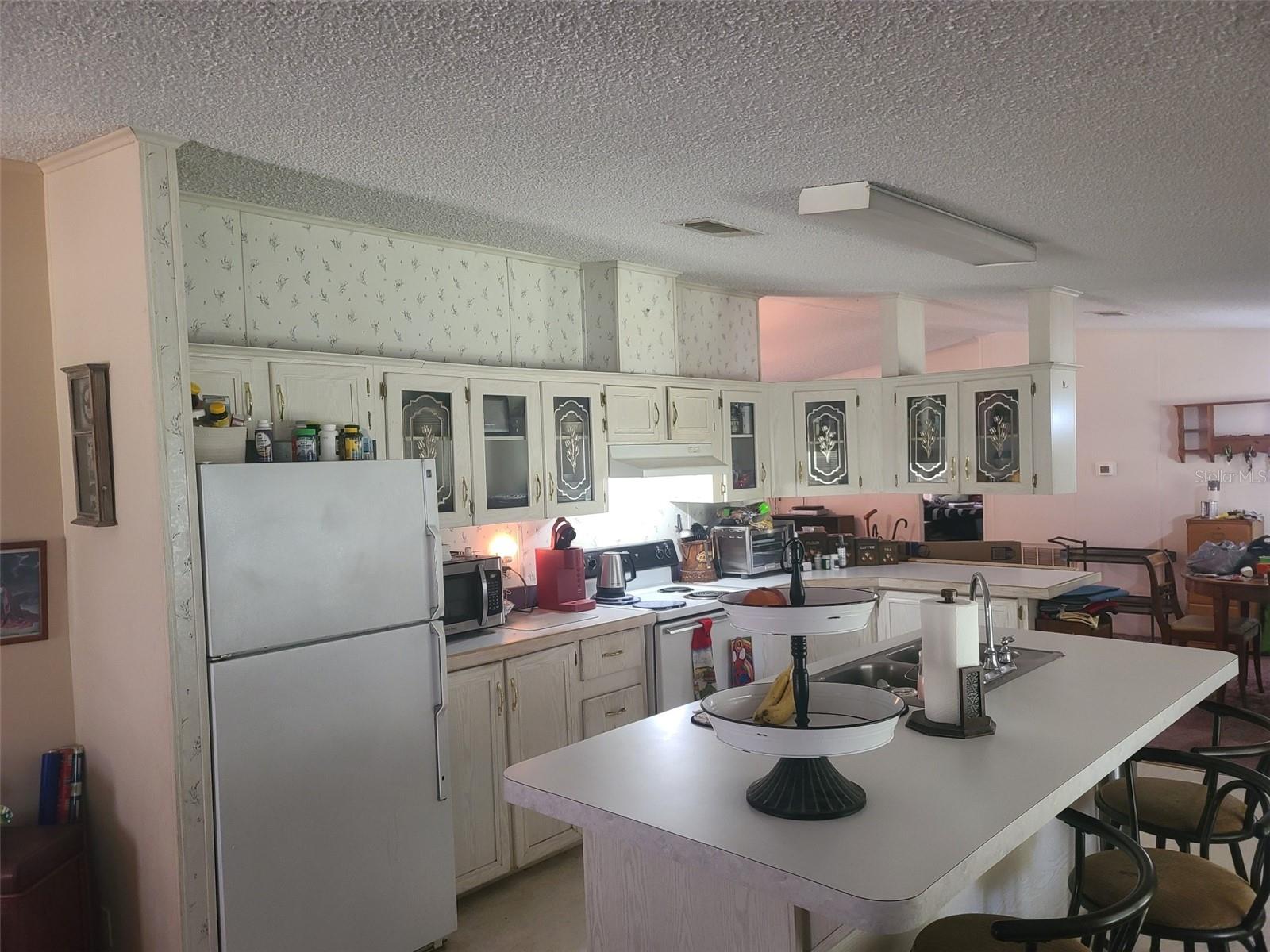 Large Open Kitchen off FR, DR, and LR, also has a back screened porch with access to covered car port (which currently has a pool table) back yard.