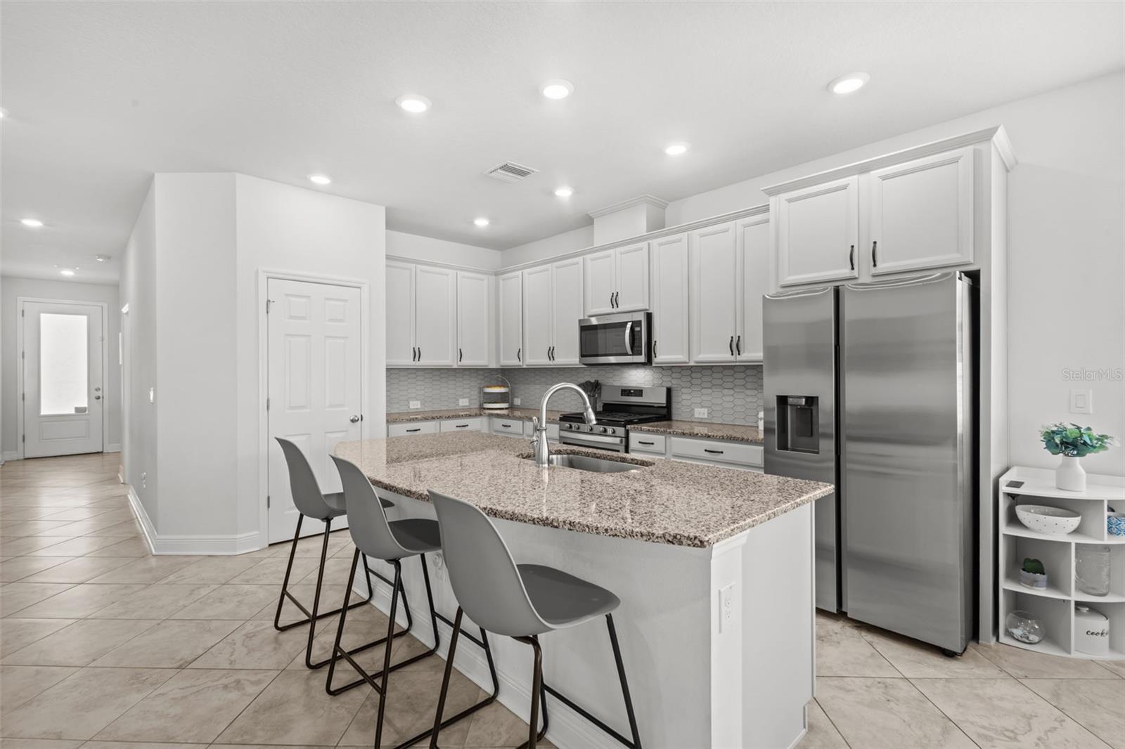 Kitchen is open to living and dining, and offers a gas range
