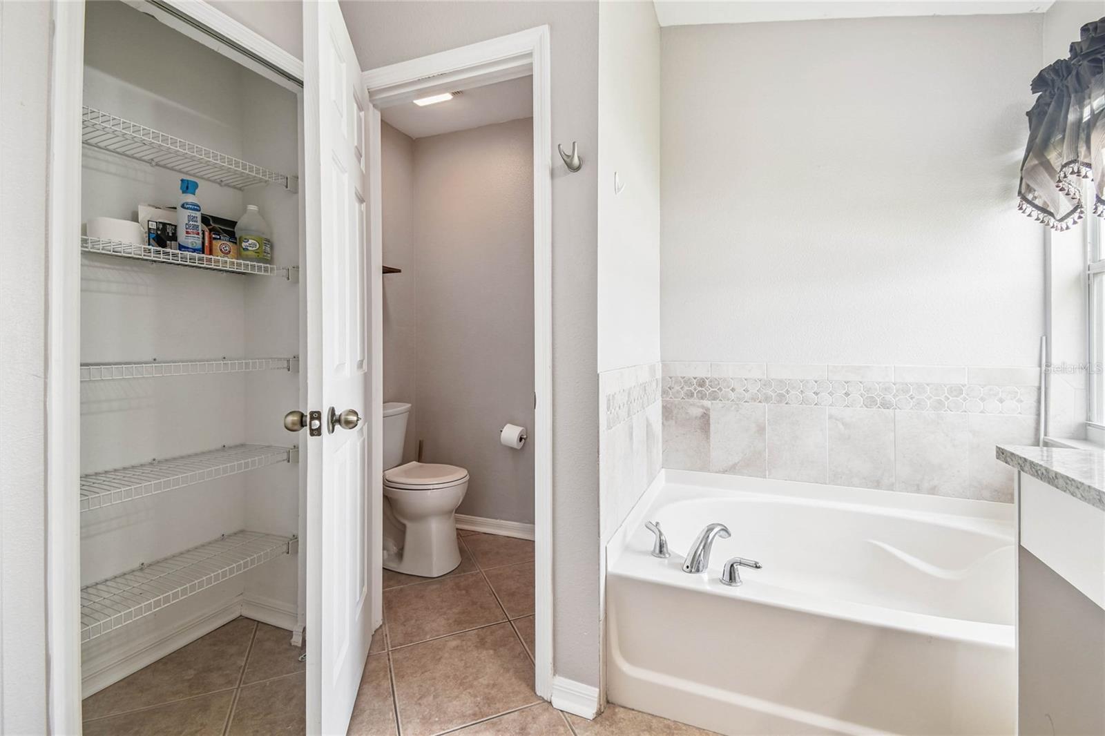 Primary bathroom includes a soaking tub, private water closet, and a linen closet.