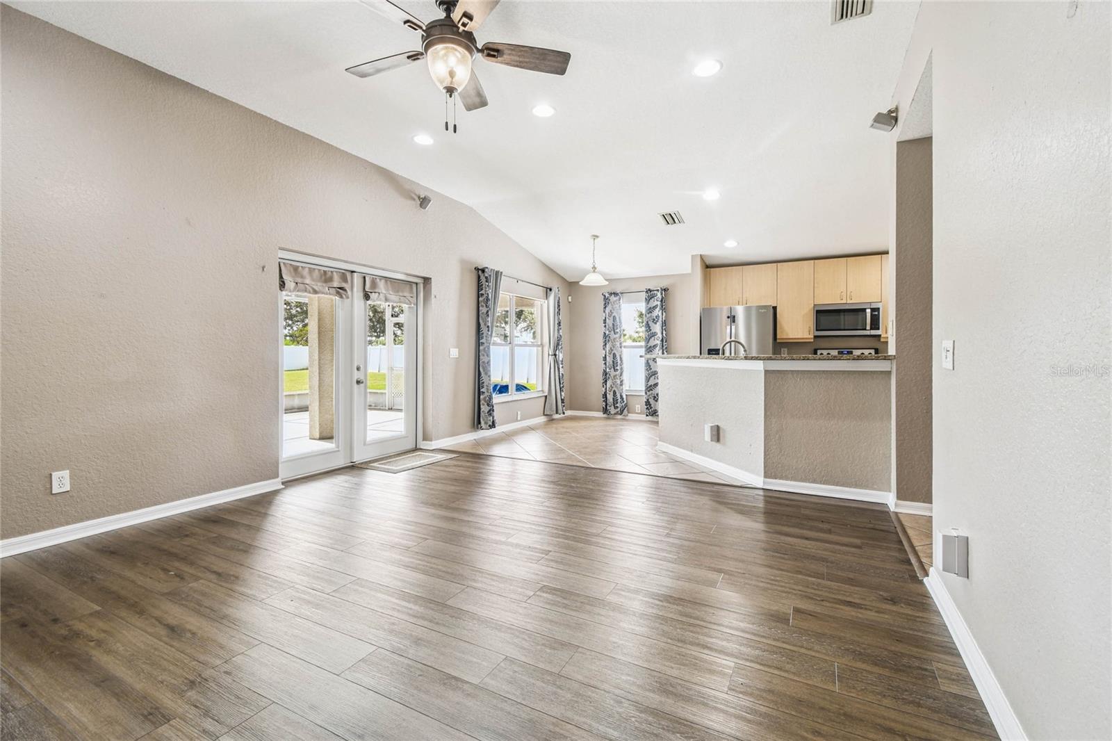 This great room is the center of the home and the french doors and windows allow for plenty of natural lighting.