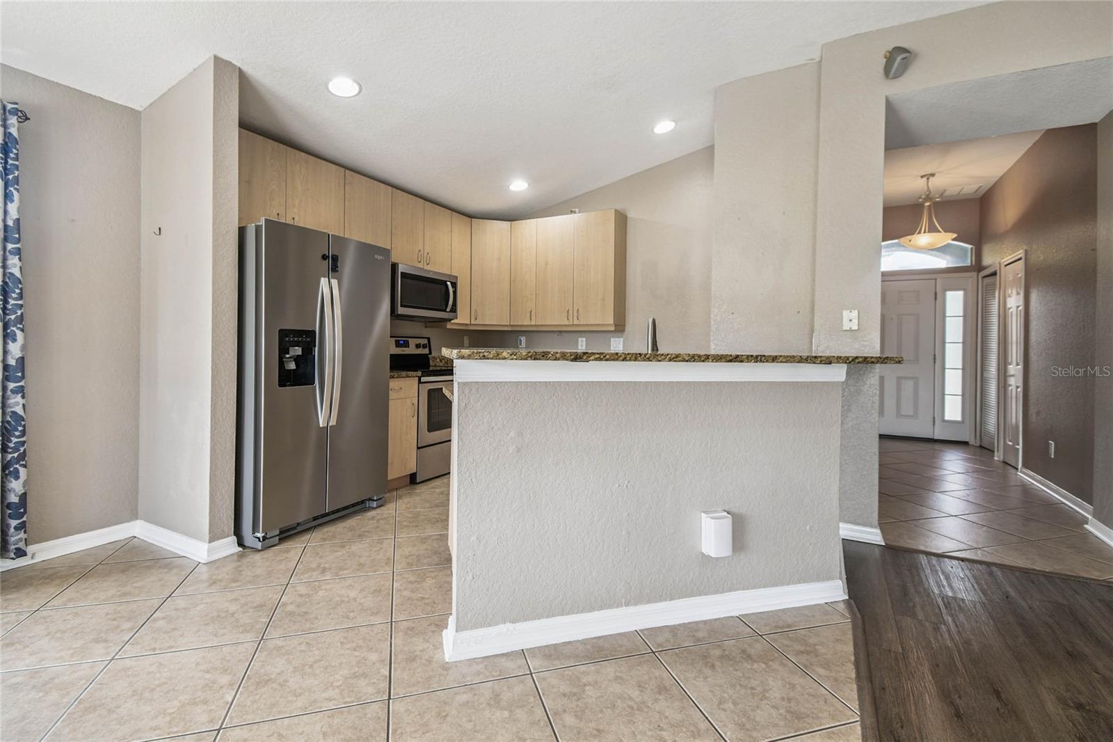 The kitchen is has newer appliances and has additional seating at the counter.
