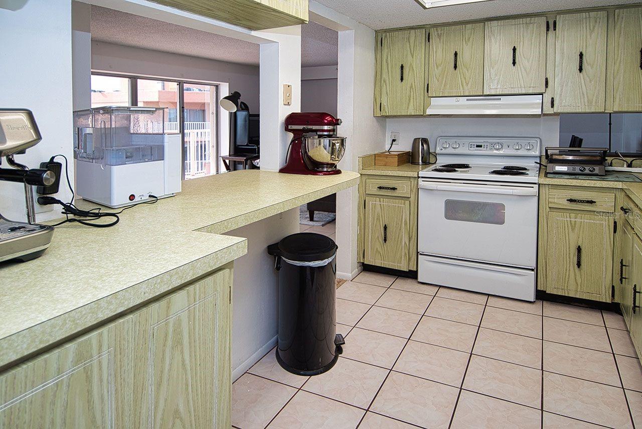Open kitchen with pass thru and view to balcony