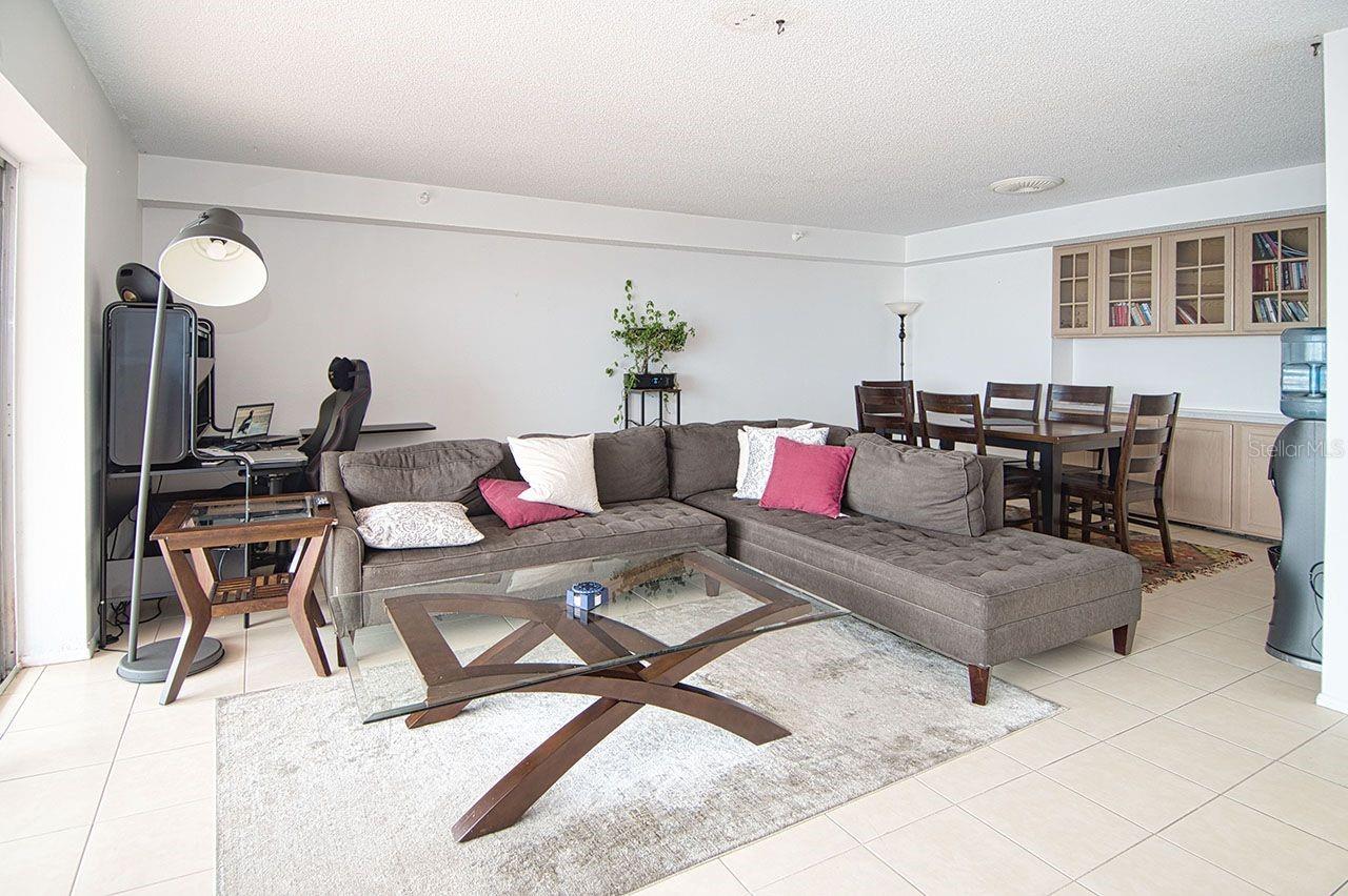 Living and Dining Room combination.  Dining area offers abundance of built in cabinets and overhead glass enclosed bookcase/display area