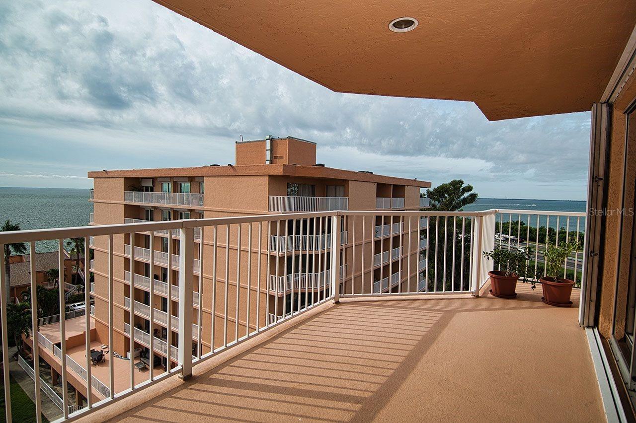 Open air covered balcony off living area.