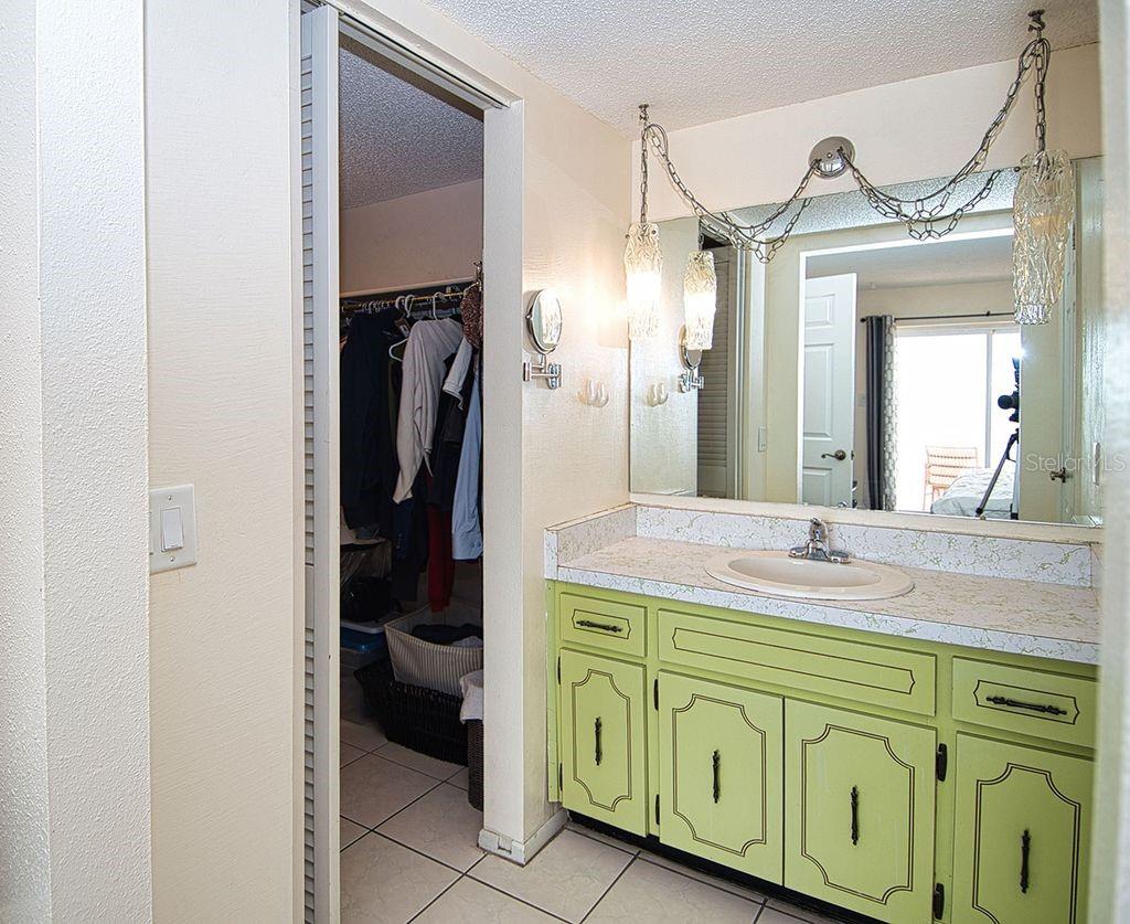 Dramatic retro style vanity leads to expansive walk-in closet.
