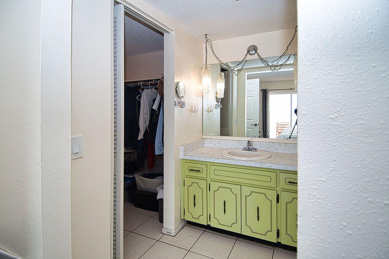 Master vanity, walk-in closet, tile flooring