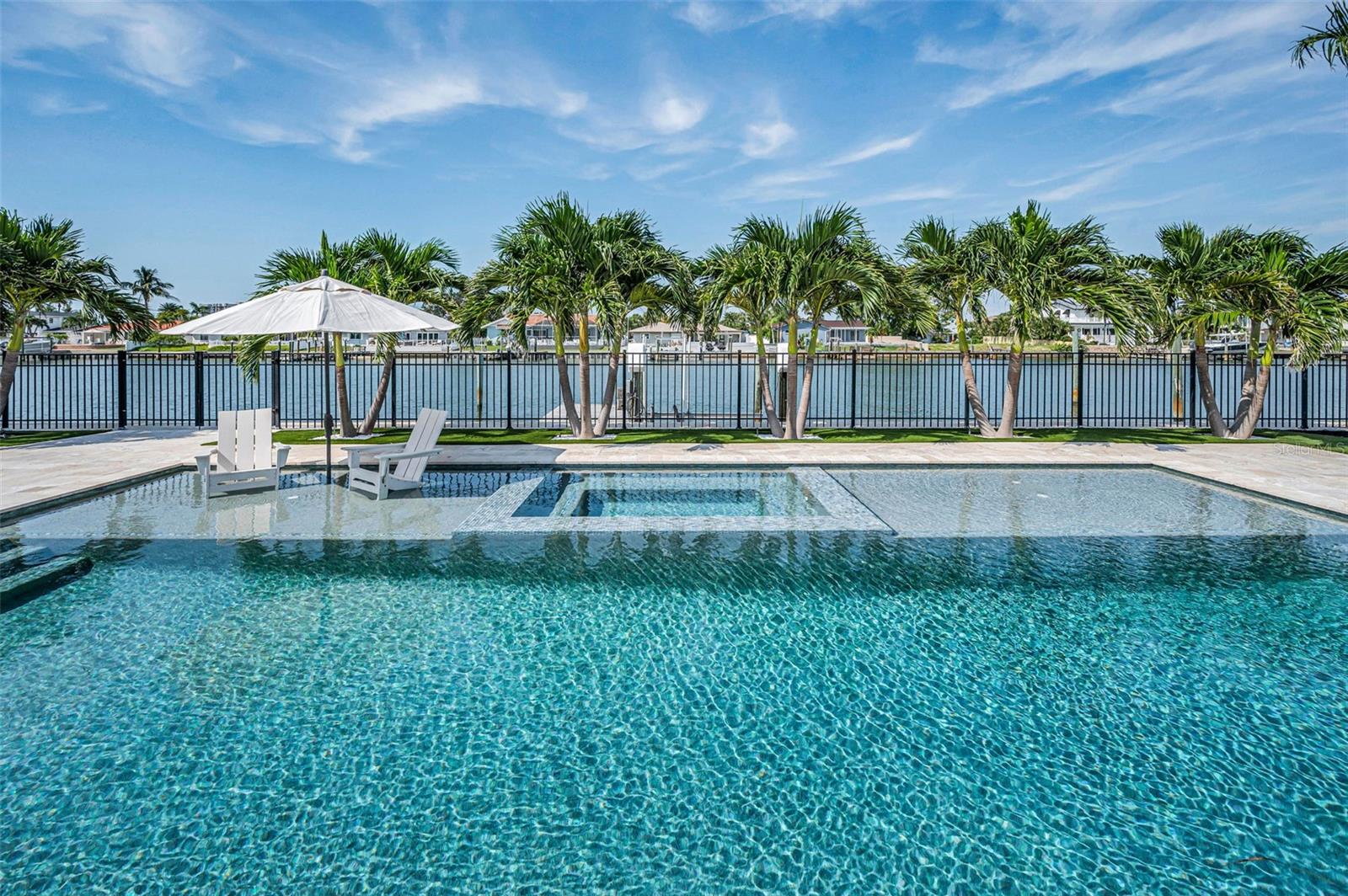 Step outside to a backyard oasis featuring a brand new resort-like sparking pool with sweeping water views.
