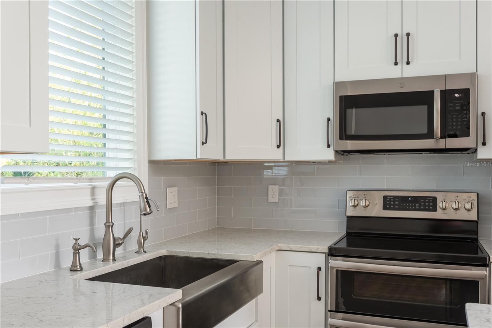 Kitchen sink, backsplash and appliances.