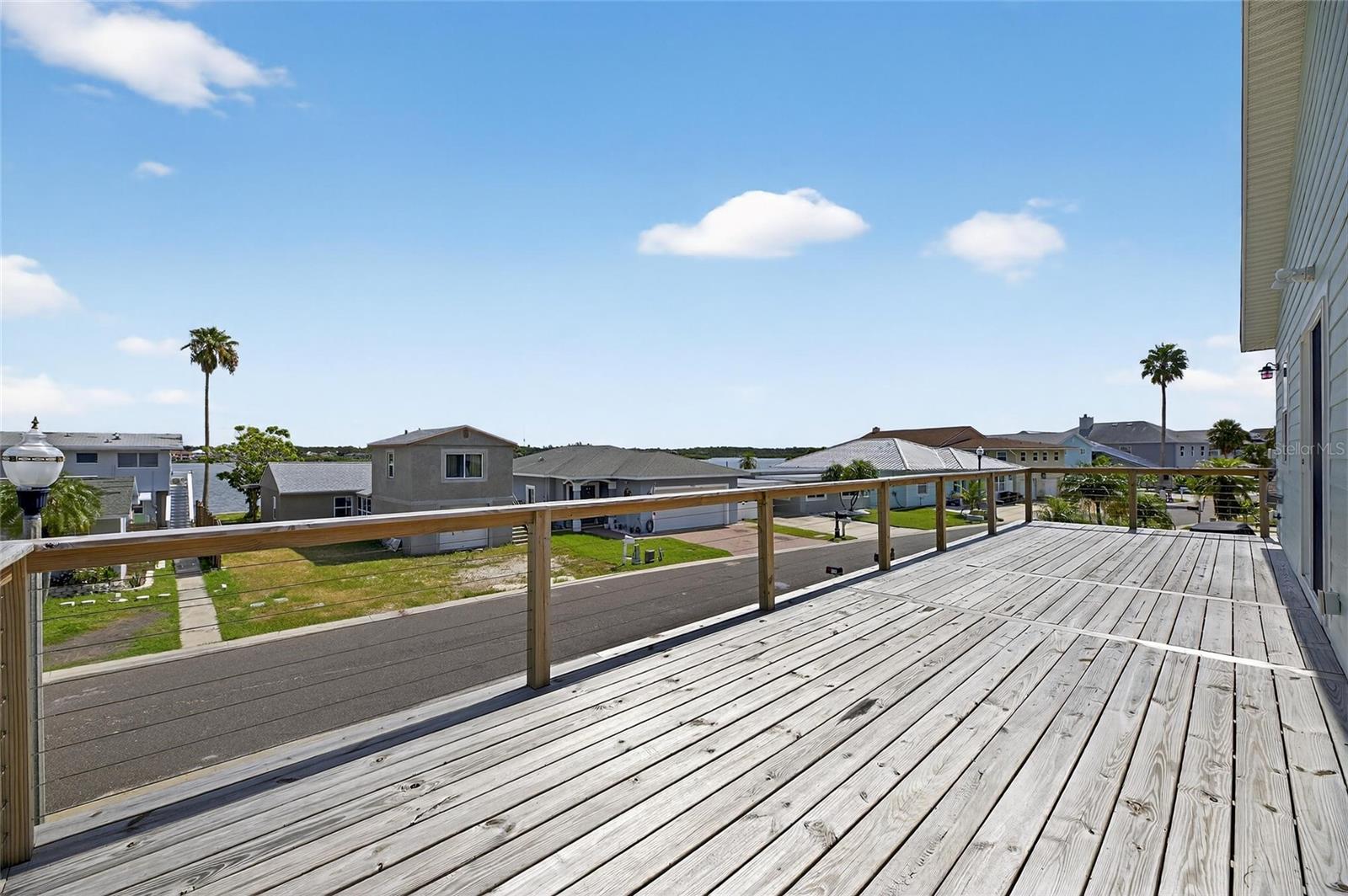 Enjoy your favorite beverage or the sea breeze from your ample wooden deck.