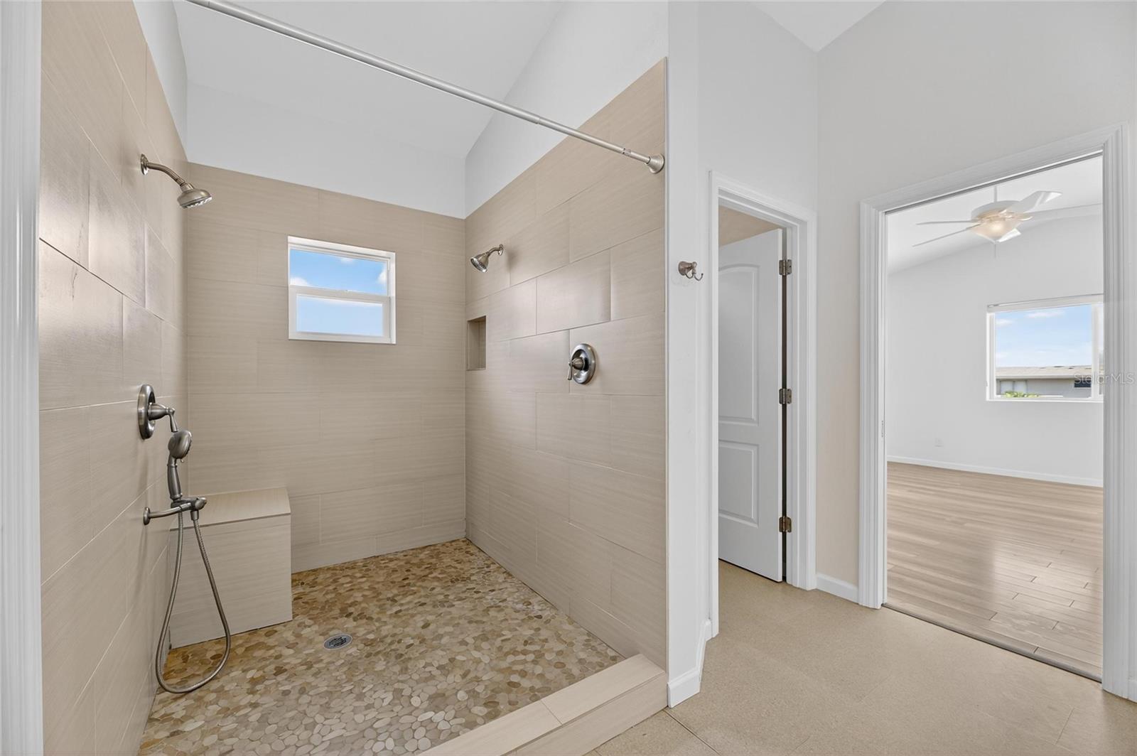 Create your very own spa experience with multiple shower heads and a built-in bench