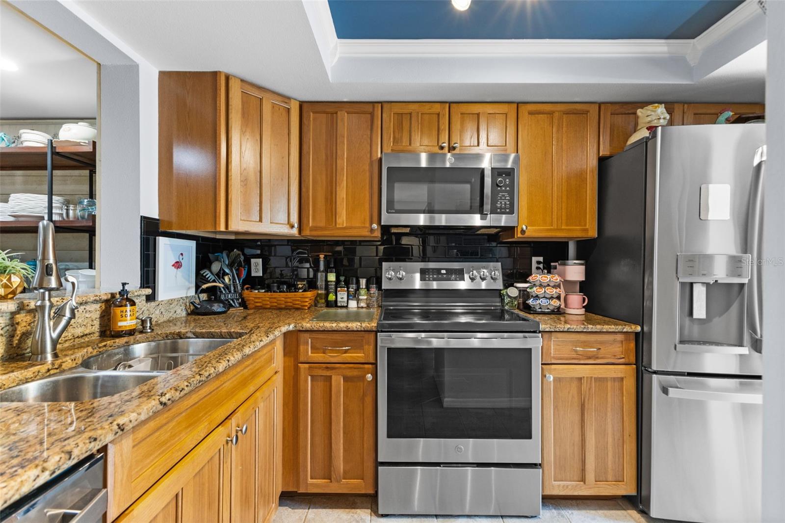 Granite countertops and wood cabinetry.
