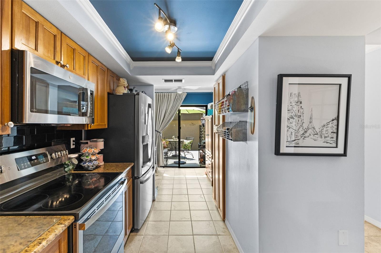 Follow the hall to an extra room located off of the kitchen, and sliders leading to the patio.