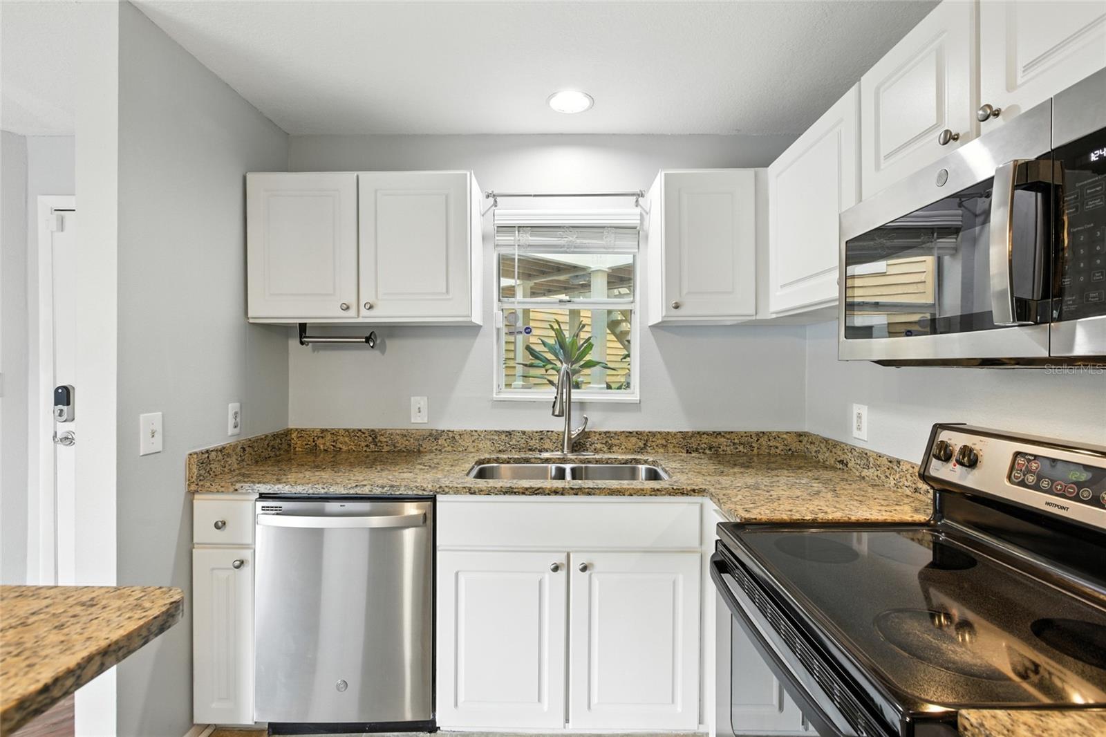Granite counters and stainless steel appliances highlight the updated kitchen