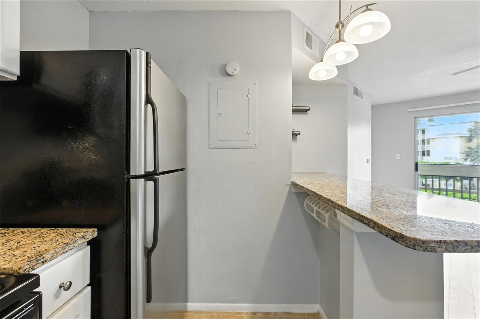 The kitchen opens directly into the living space and a screened-in porch overlooking the lake.