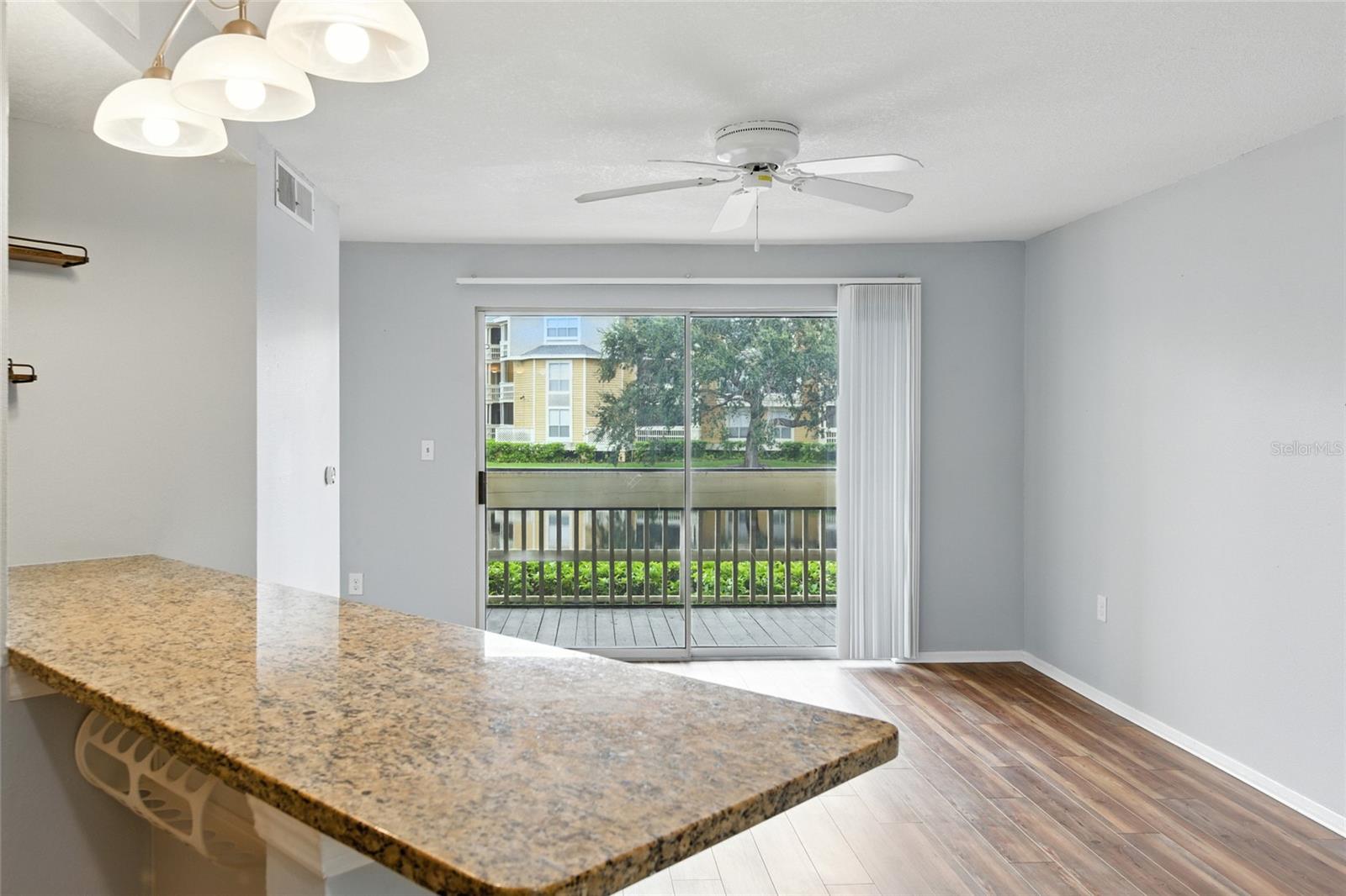 Depth and light — kitchen connects smoothly to the screened in porch and lake views