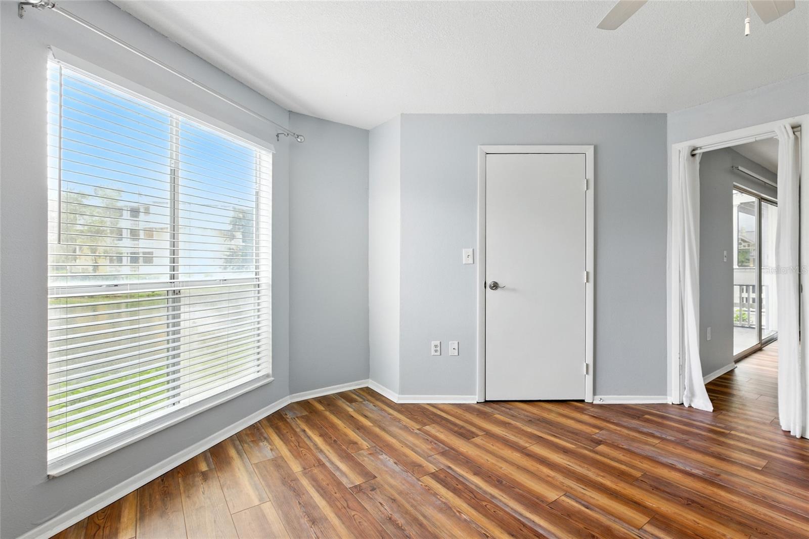 Primary bedroom with large window providing natural light and beautiful lake views