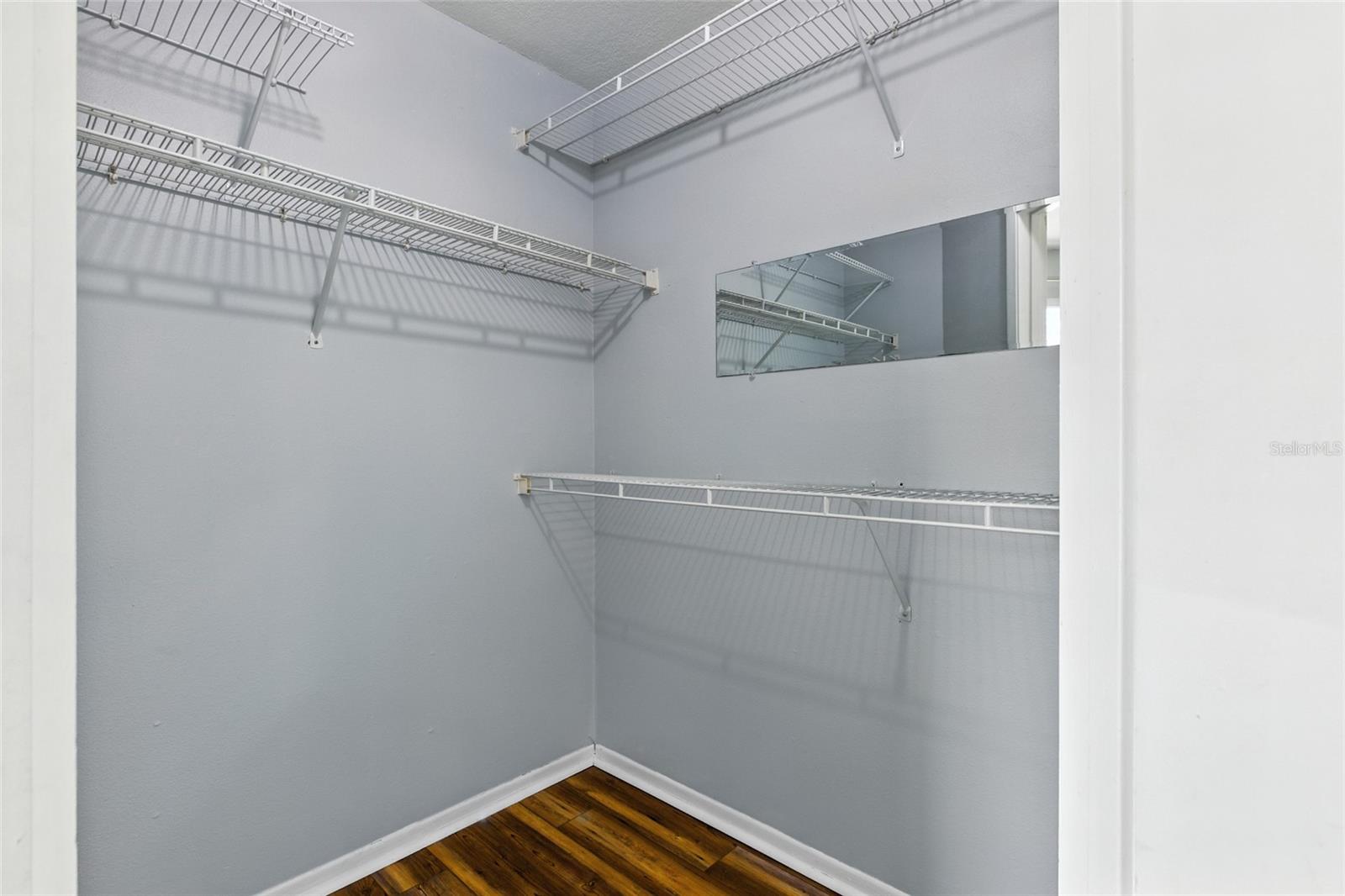 Walk-in closet in the primary bedroom with ample shelving and organization space