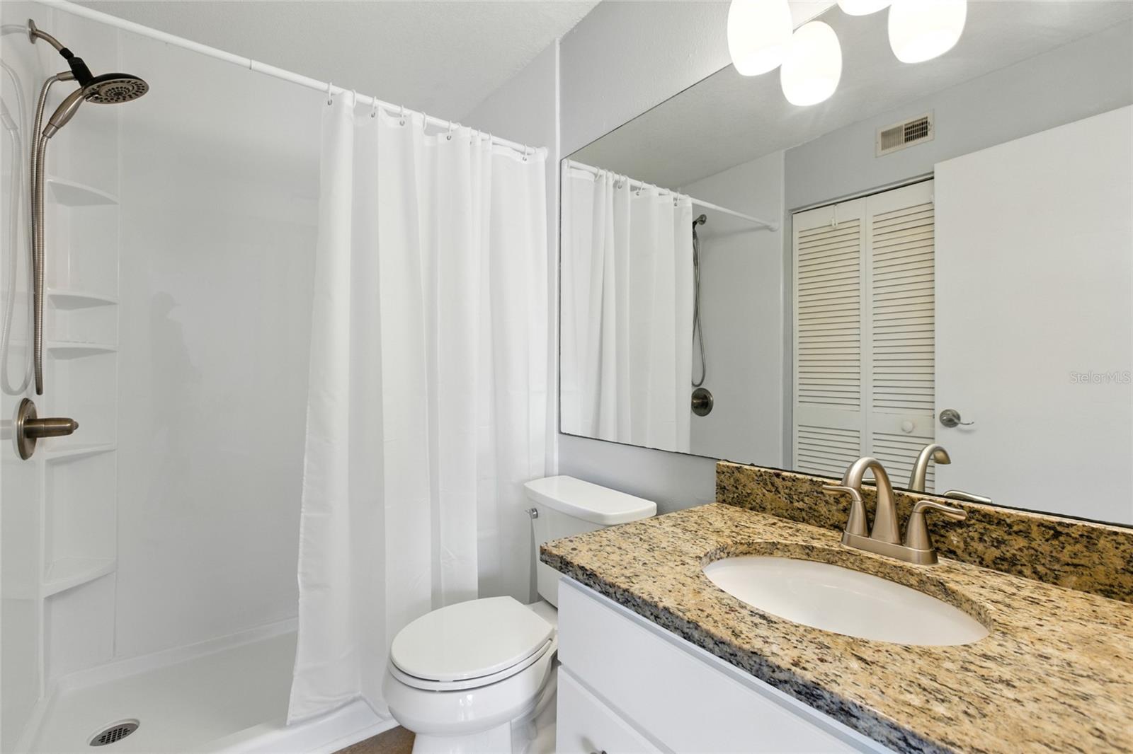 Spacious bathroom with granite vanity and a large walk-in shower!