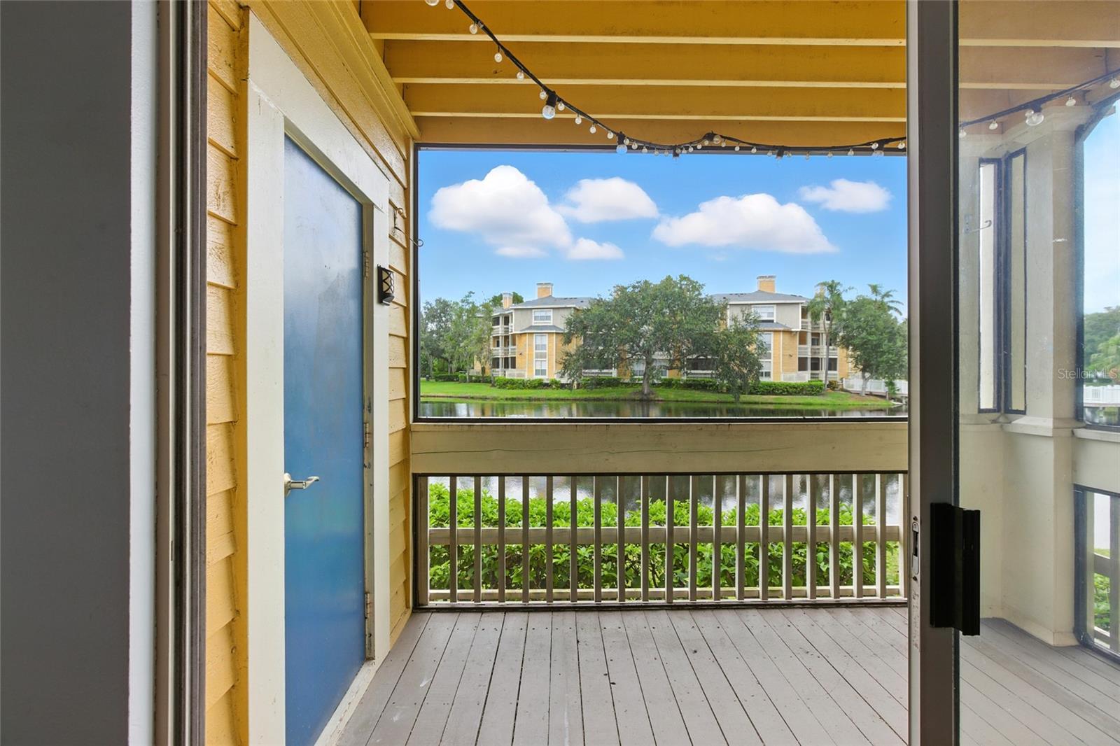 Screened porch offers a peaceful spot to relax with a view of the community lake