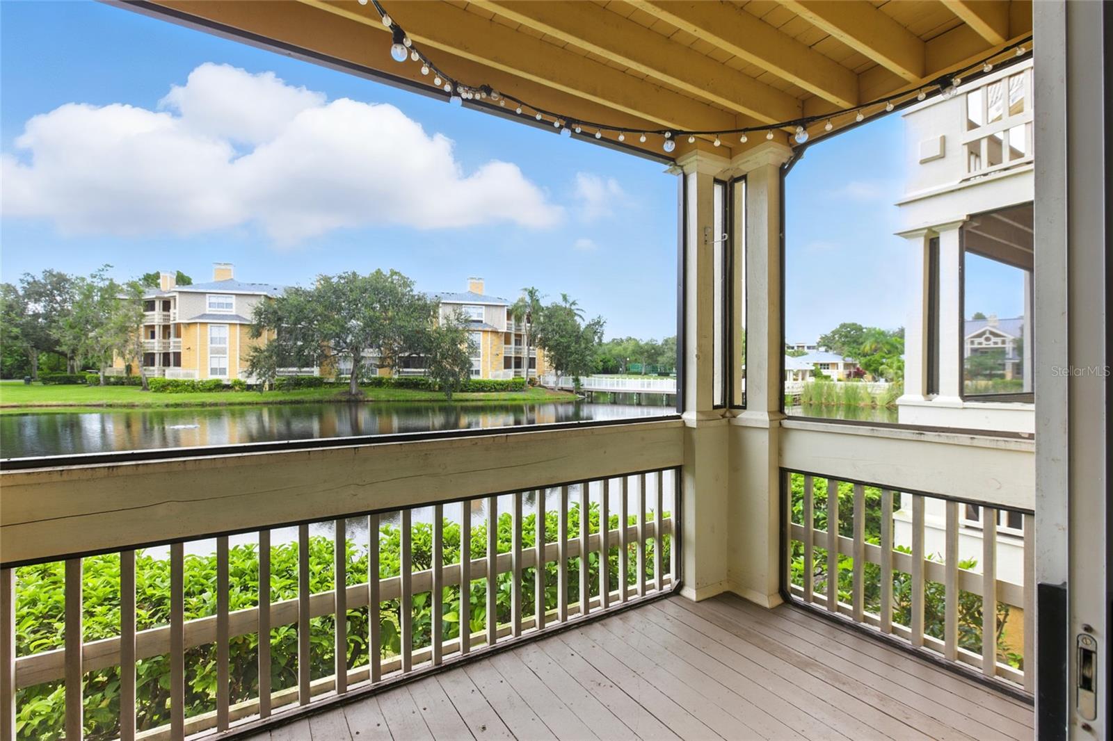 The screened porch extends your living space outdoors with tranquil lake views.