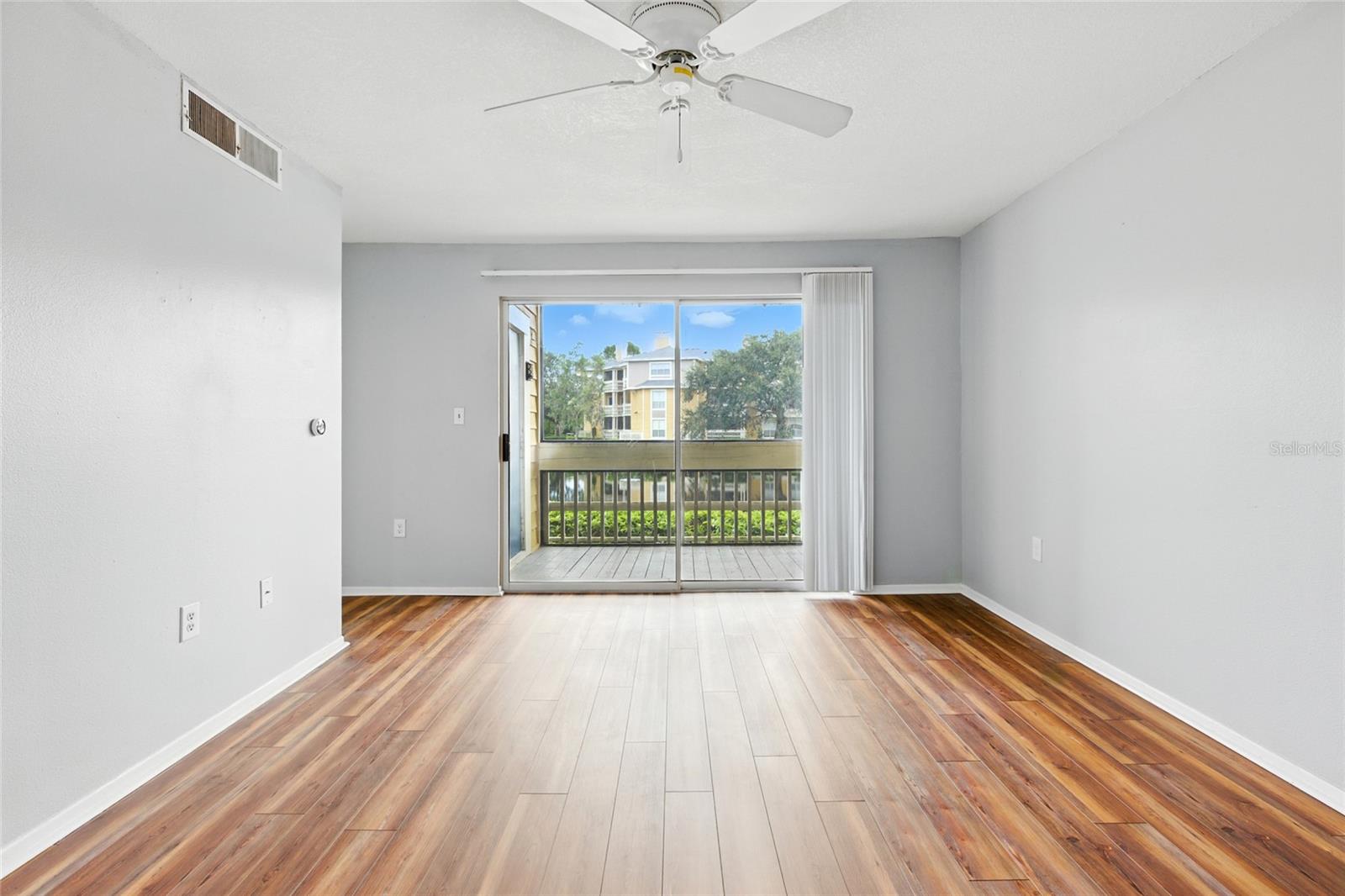 Living room opens to a private balcony overlooking one of the largest lakes in the community!