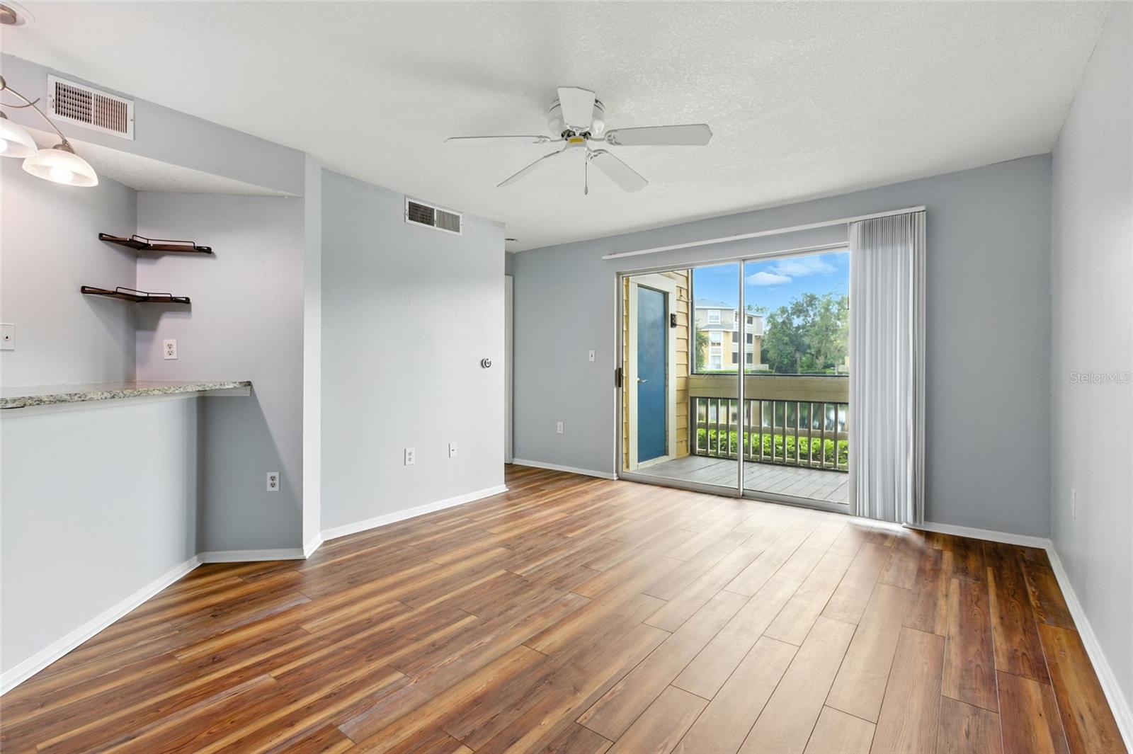 Open living area with a seamless flow to kitchen, bedroom, and balcony