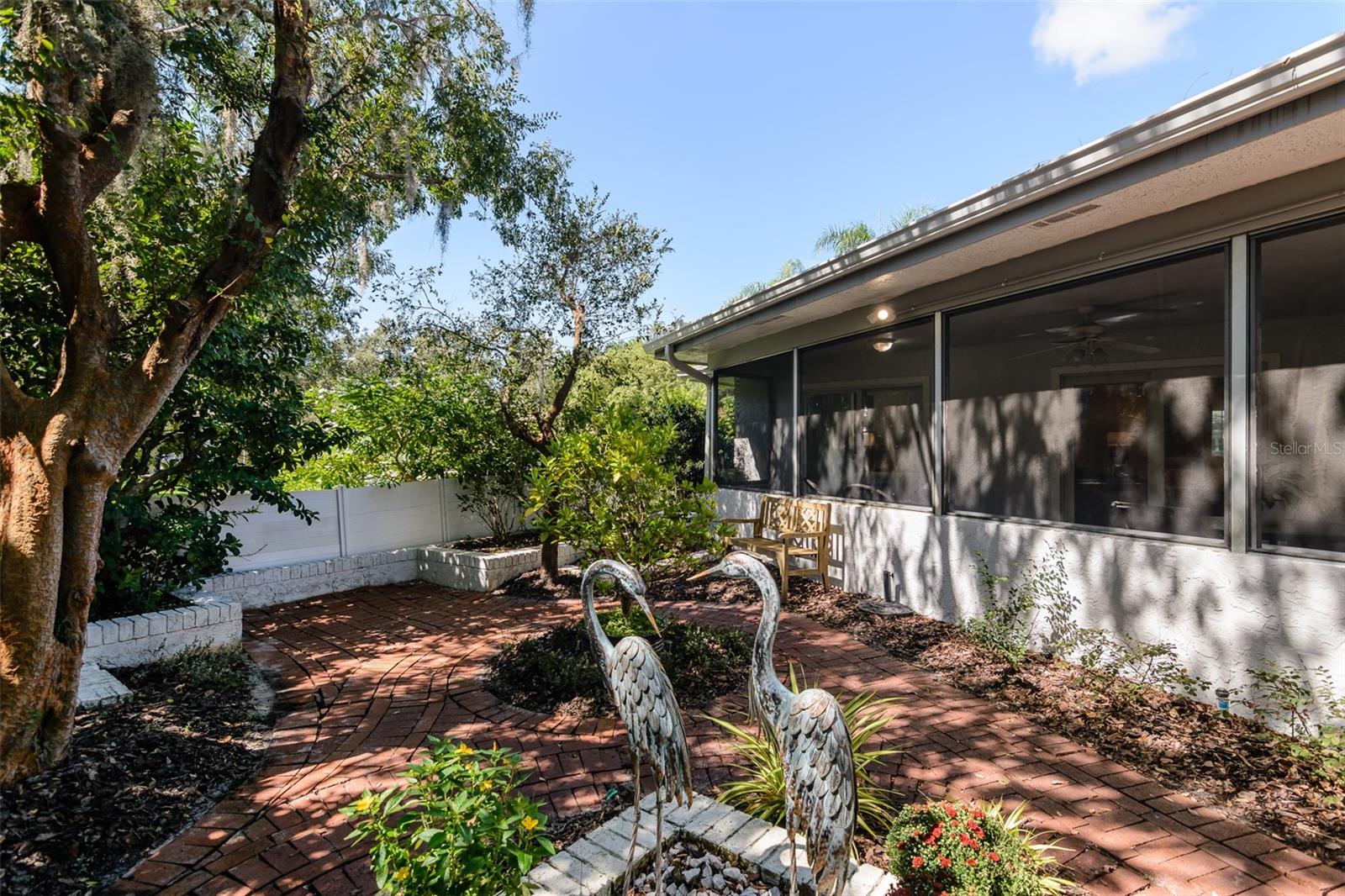 Screened lanai overlooks the garden.