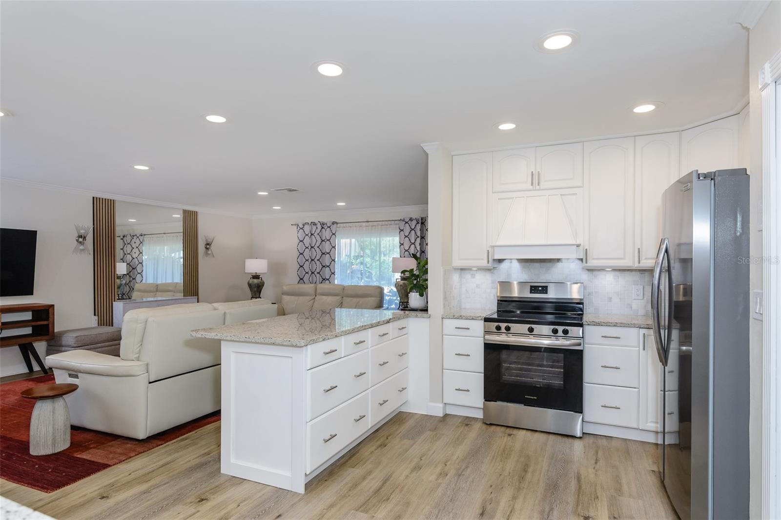 Kitchen opens to living room/dining room space.