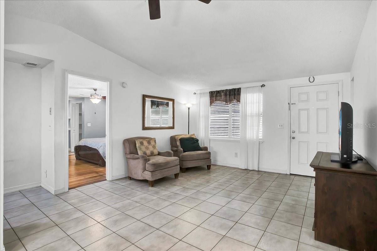 view of living room and primary bedroom
