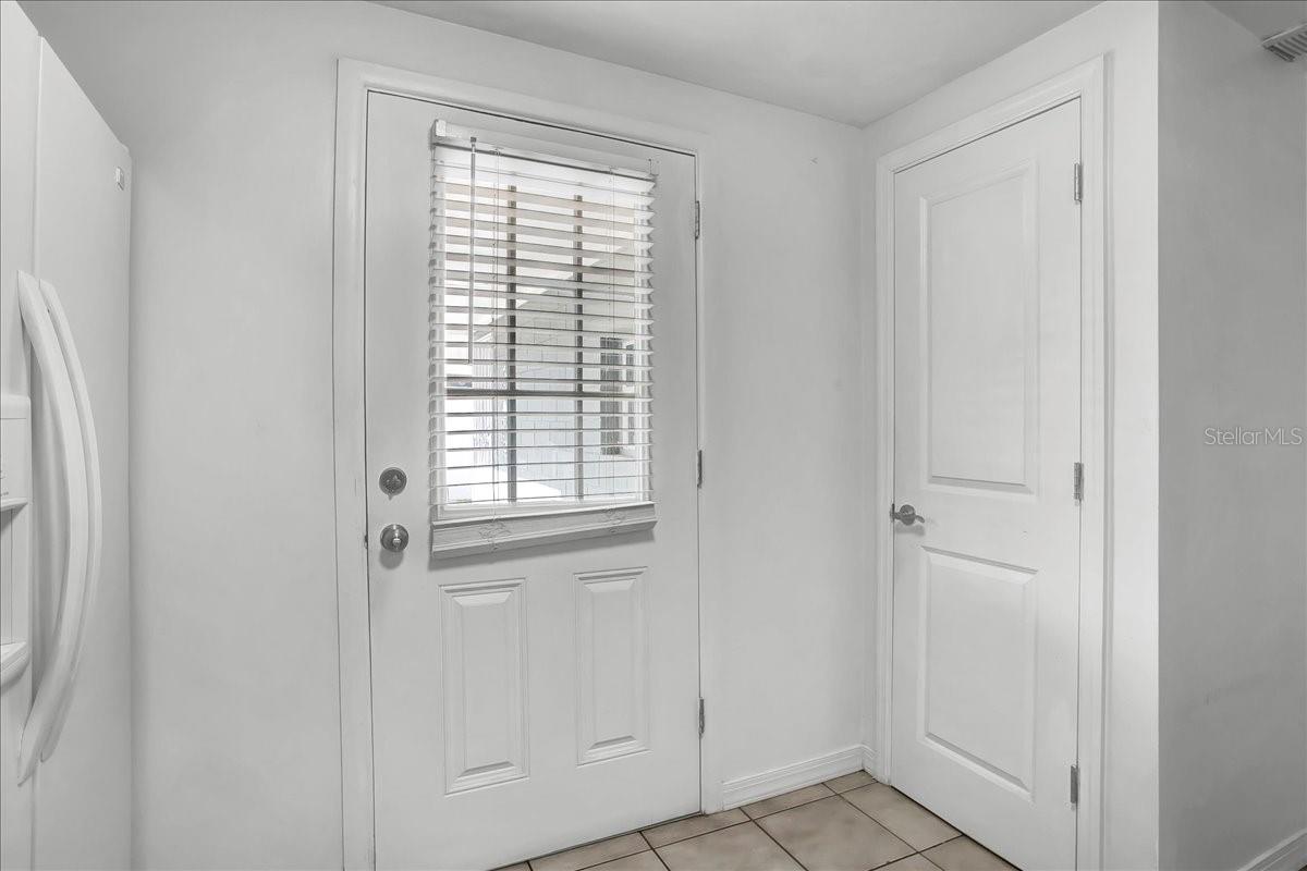 door to backyard located in kitchen