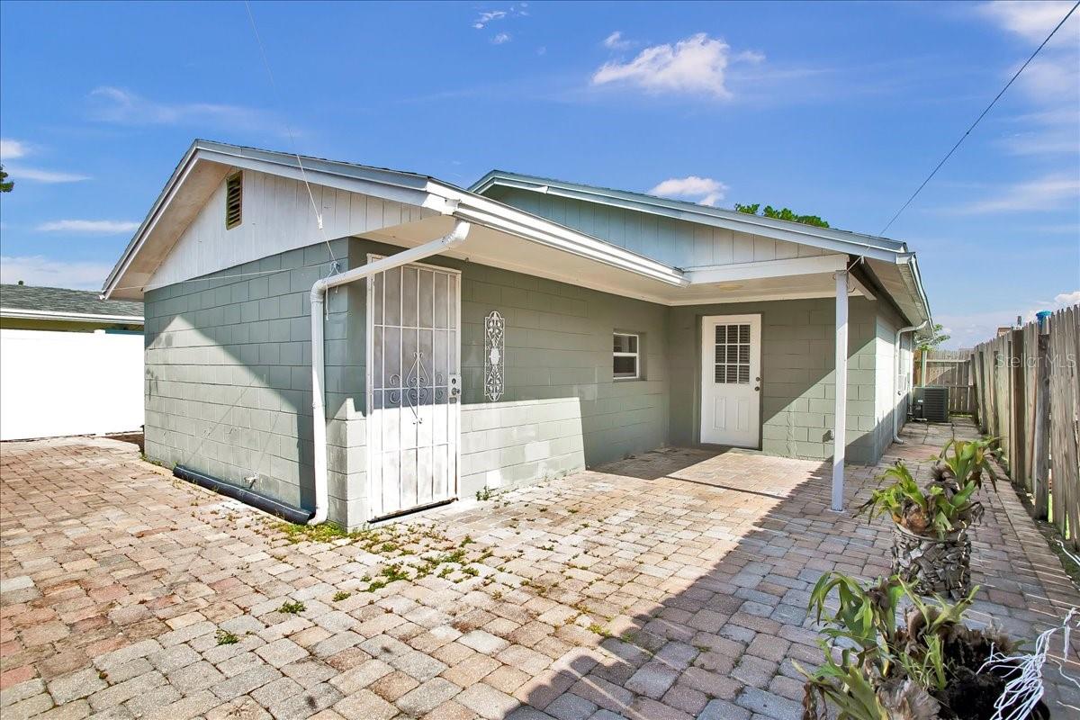 view of laundry room and kitchen entrance from backyard