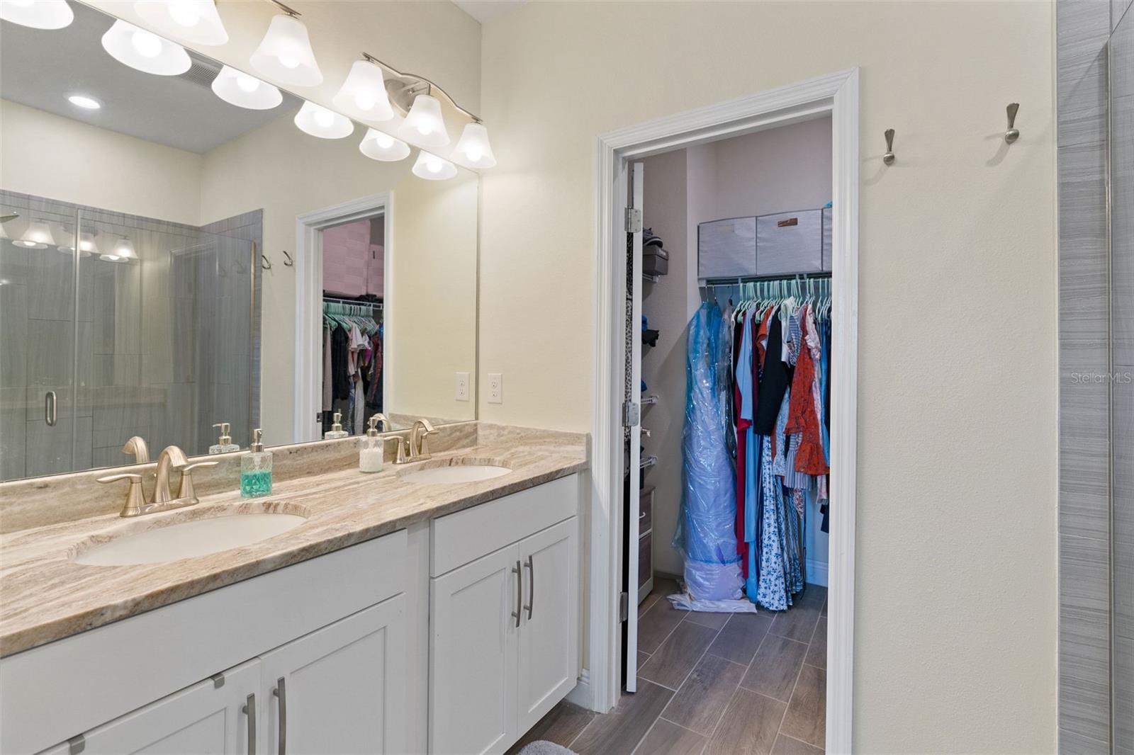 Double vanity and walk in closet. Separate toilet