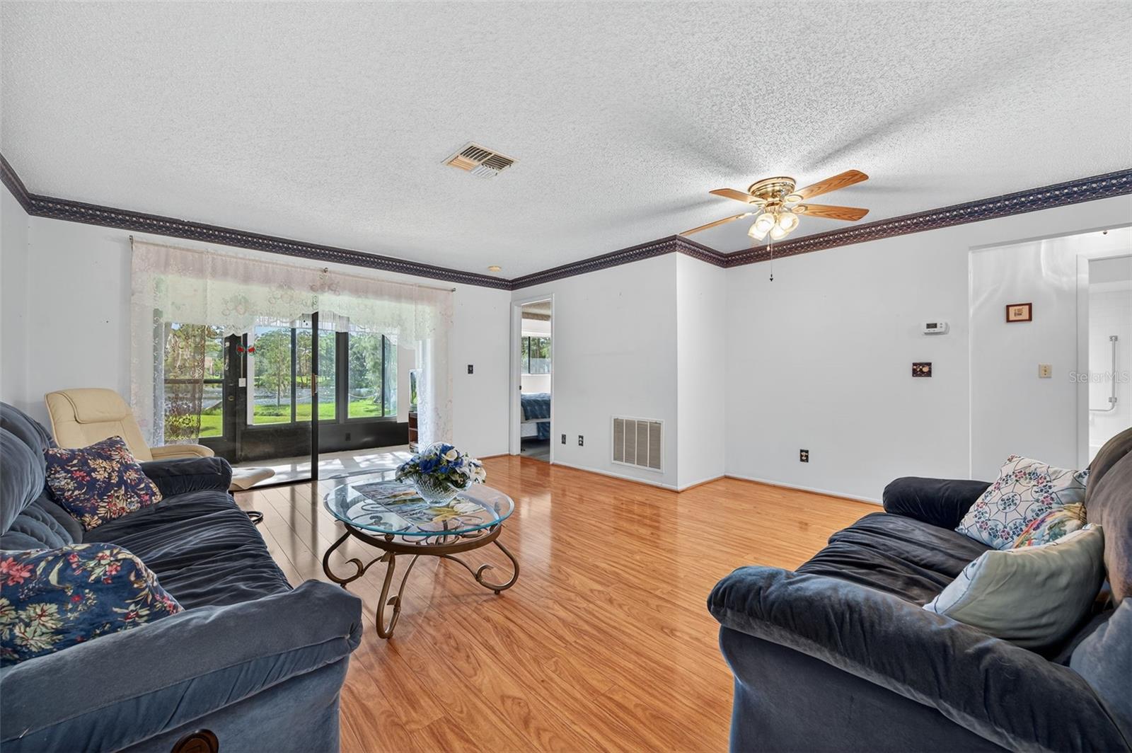 Living room leads to the Florida room with a beautiful view of the lake