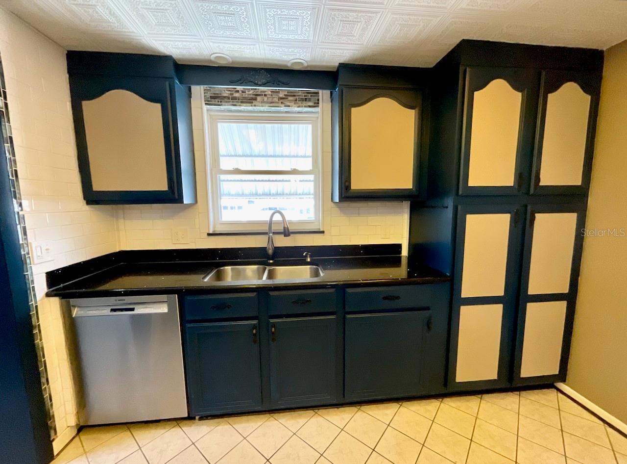 12- Kitchen sink area with unique pantry cabinet