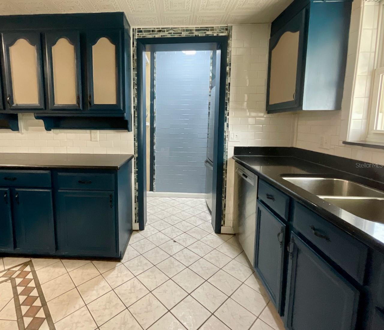 14-Kitchen walk in to to refrigerator, small microwave and extra storage shelves
