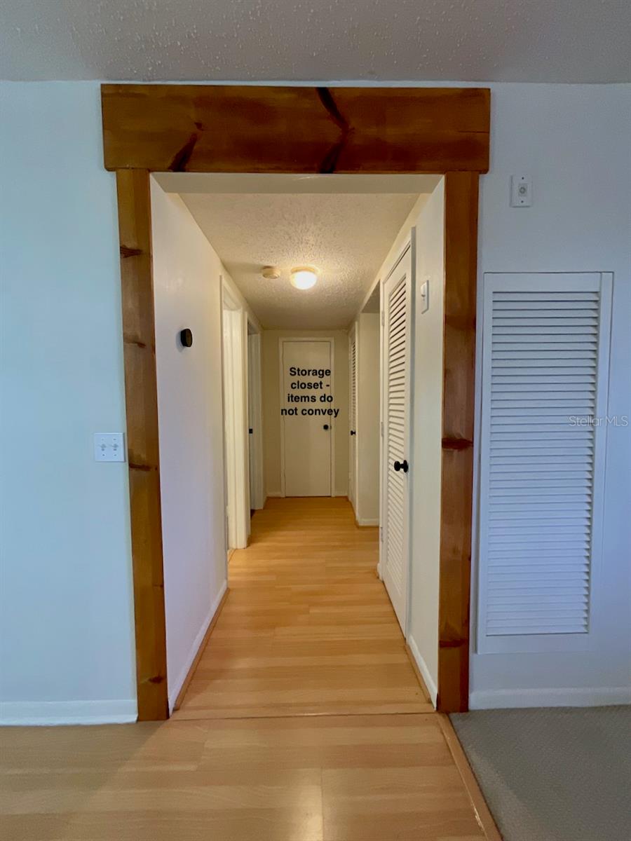 18-Hallway to bedrooms, guest bath, and large storage room