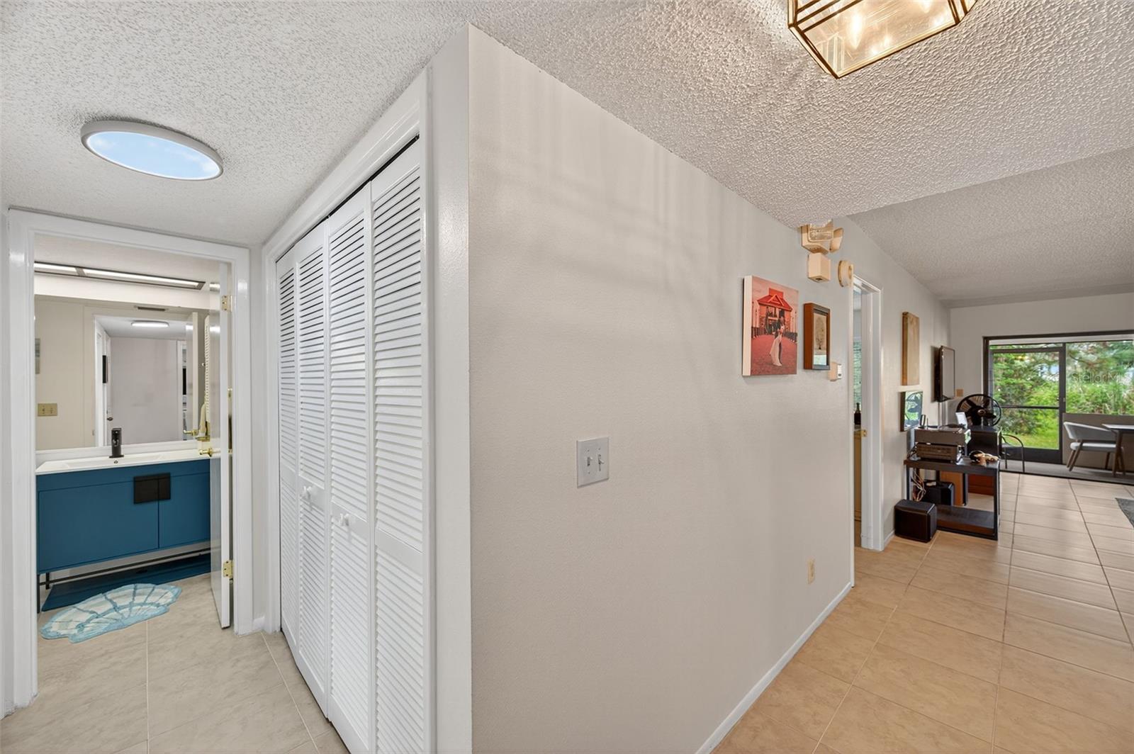 Hall to guest bathroom with laundry closet