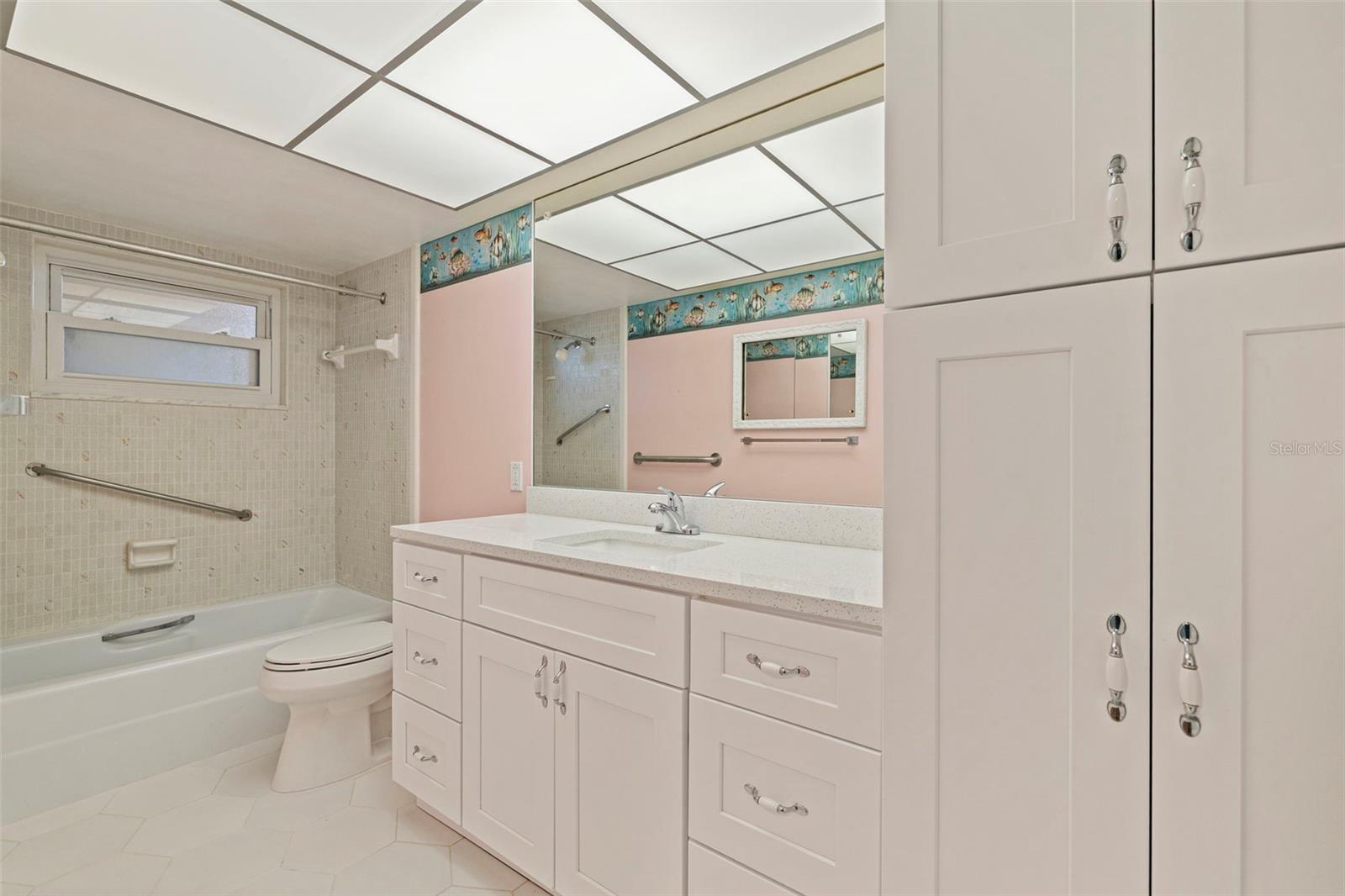 Guest bathroom with tub and overhead shower