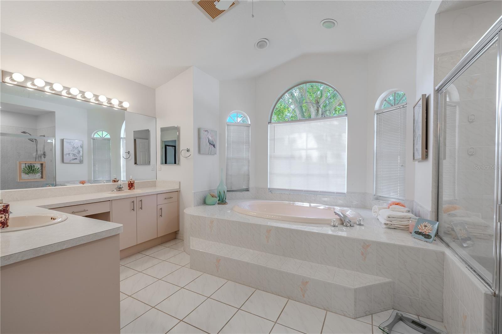 The primary bath offers a relaxing soaking tub, walk-in shower, dual vanities, and a private toilet for added comfort and convenience.