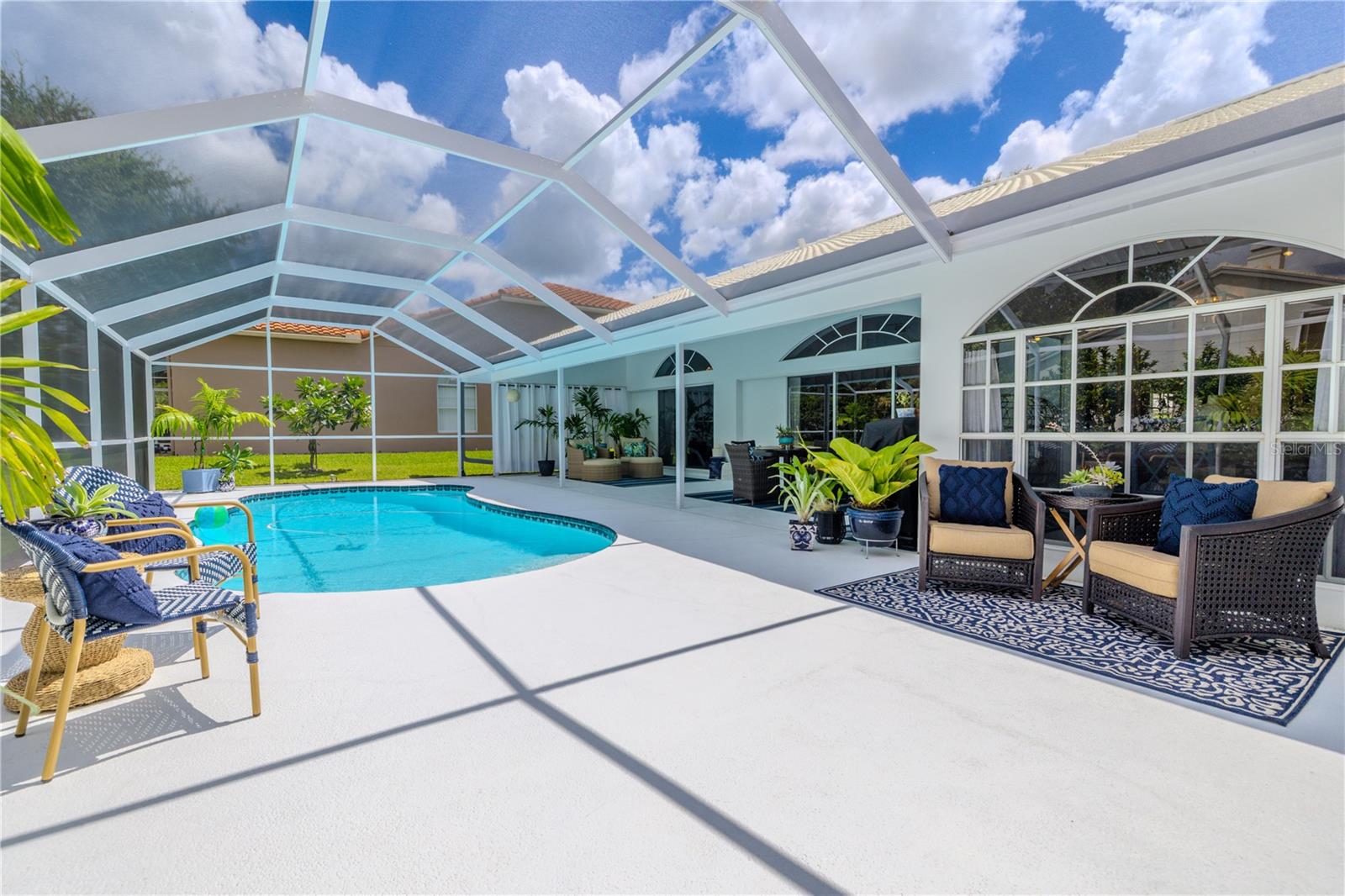 Whether you want to soak up the sun by the pool or relax in the shade under the covered lanai, this outdoor space offers multiple seating areas to enjoy.