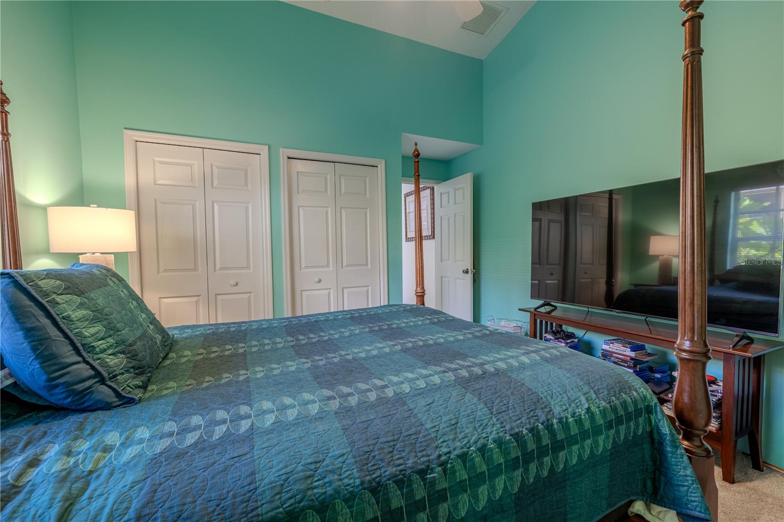 This bedroom also includes two spacious closets for storage and organization, along with ample wall space for larger furniture or media setups.