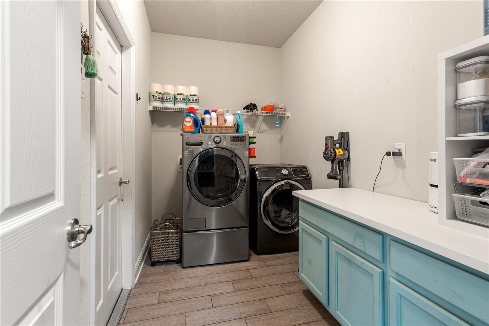 Laundry Room With Cabinets Leading To Garage