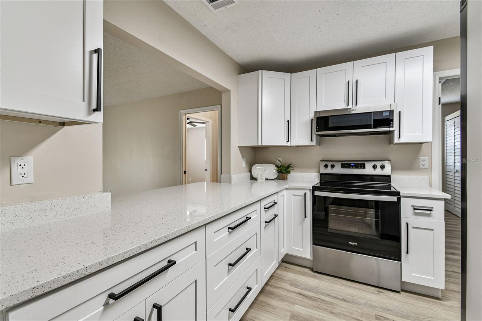 Kitchen with brand new quartz and a pass through to the family room.