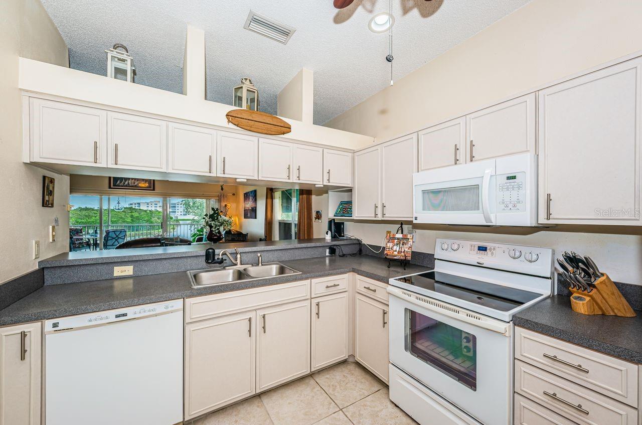 Spacious open living and dining area with vaulted ceilings and abundant natural light.