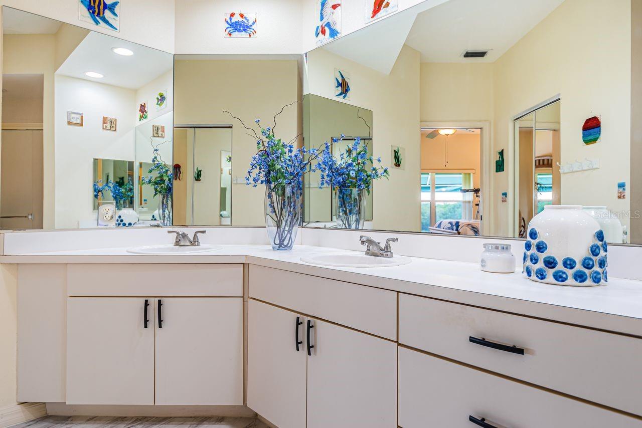 Primary bath with double sinks, oversized walk-in shower, and private water closet.