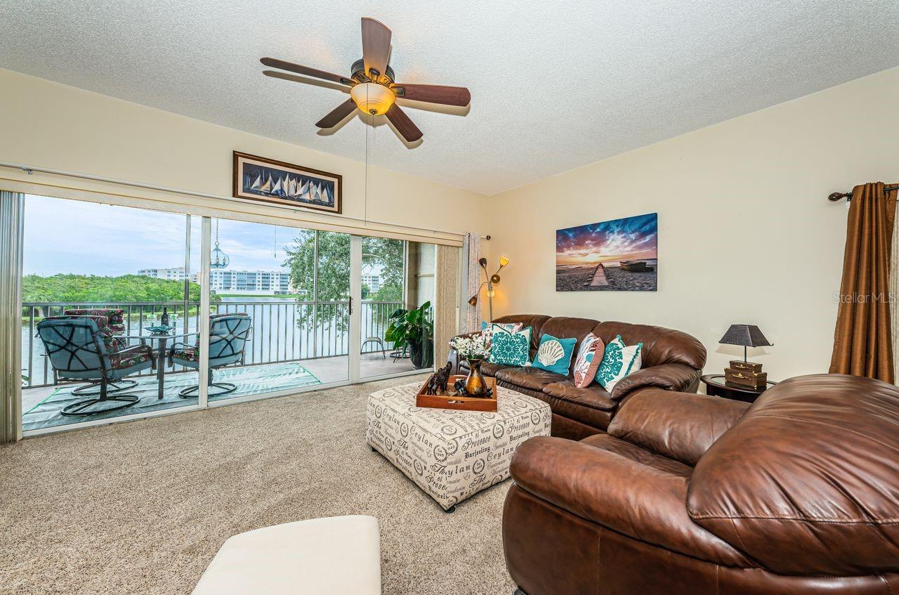 Soaring ceilings and a wall of sliders frame wide-open lake views.