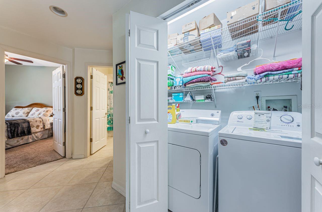Indoor laundry room with full-size washer and dryer.